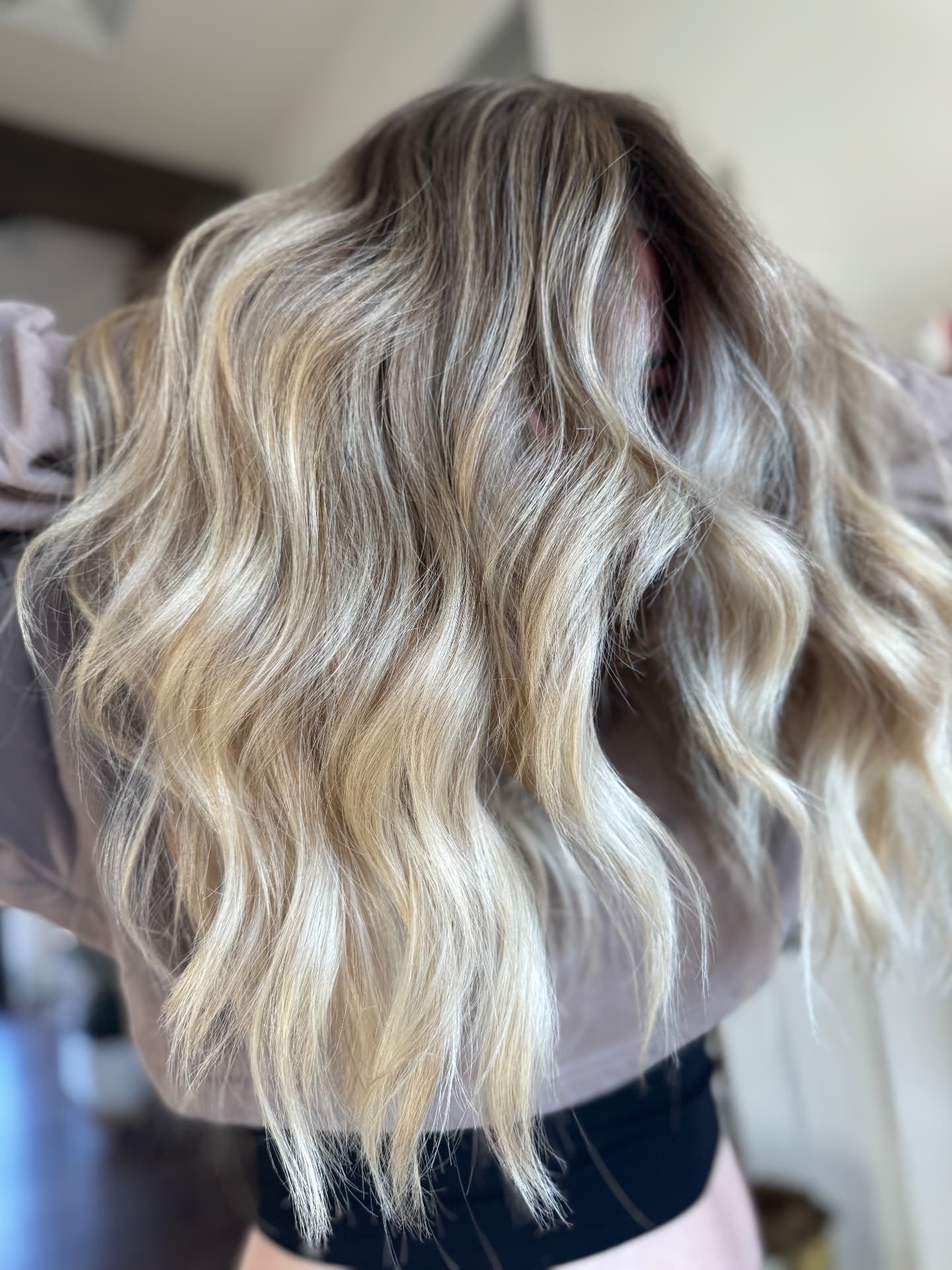 Long blonde balayage waves styled at Casa