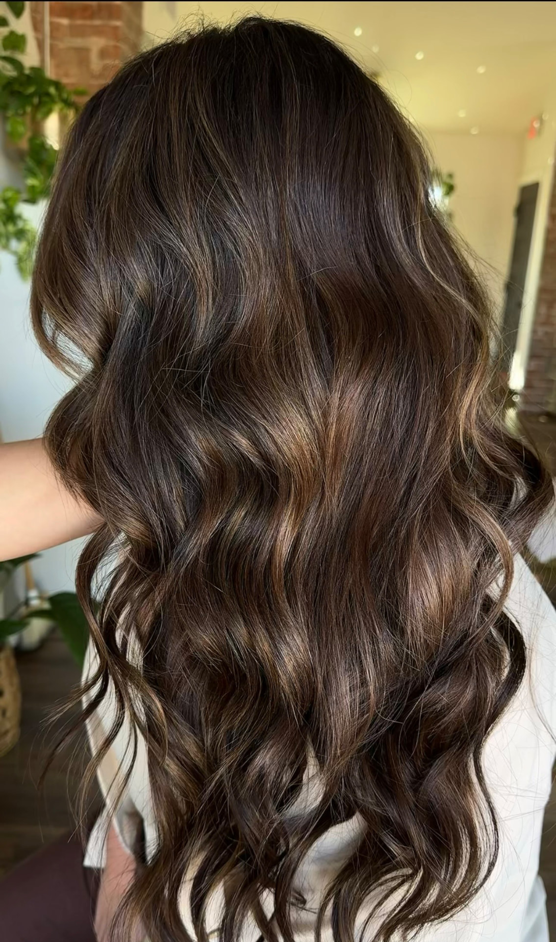 Long brunette hair with caramel highlights at Casa